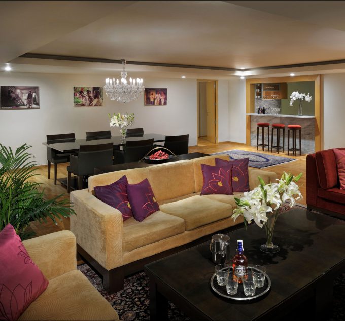 Hangover suite room couches and a centre table with a bar and dining table in back of room